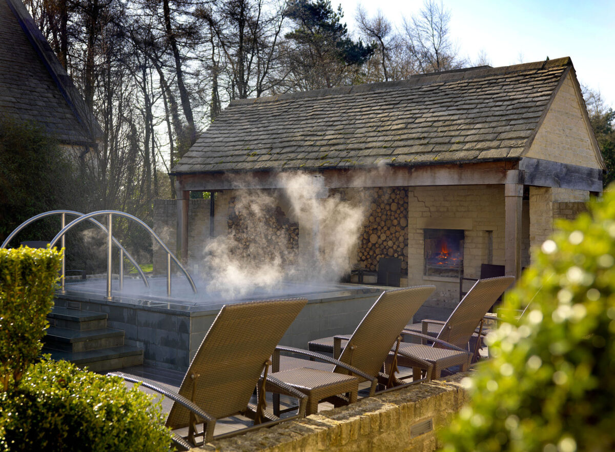 The outdoor hot tub and fire at Calcot Spa