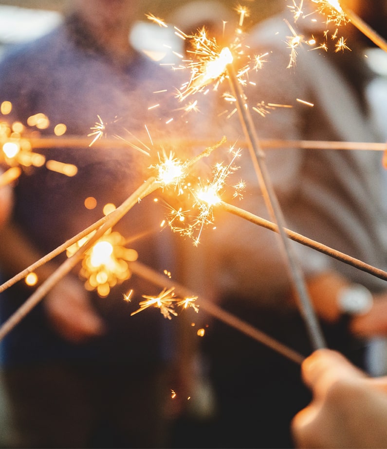 A group of people with Sparklers on New Years Eve