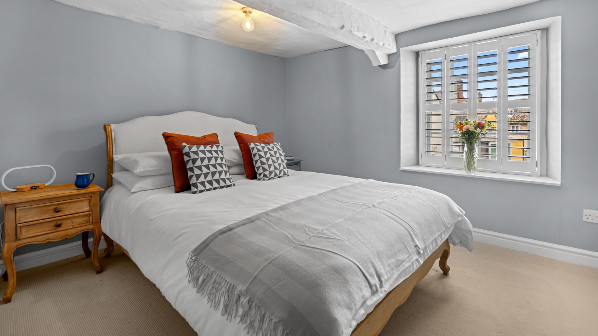 The spacious first bedroom is inviting