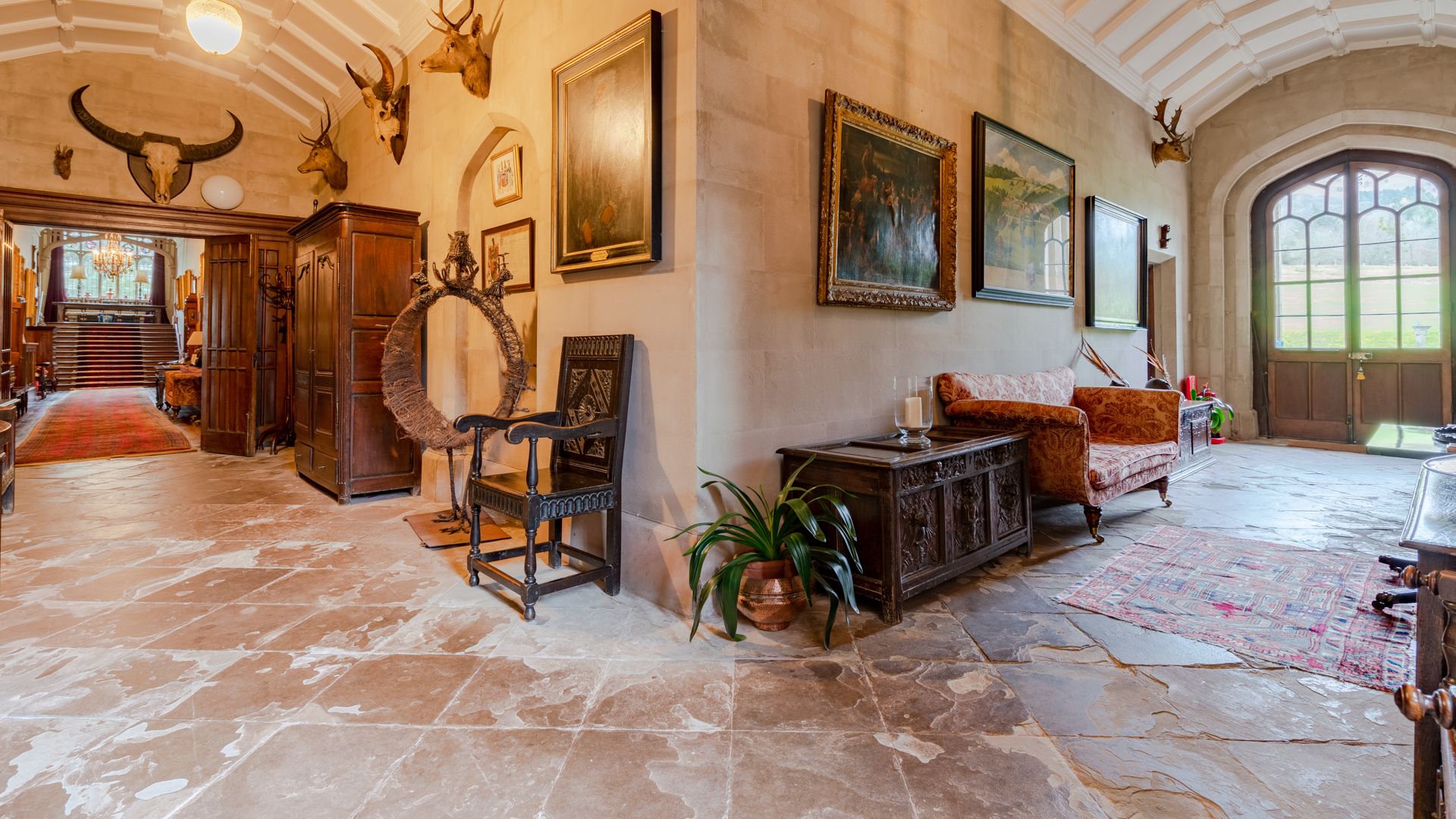 Kentchurch Court's entrance hall is detailed with an array of fascinating wall hangings